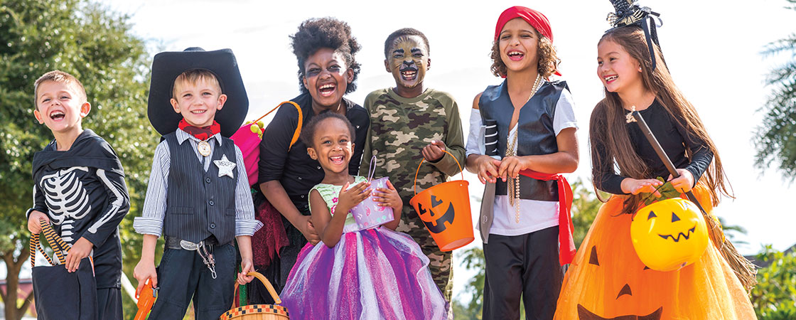 a group of kids in Halloween costumes